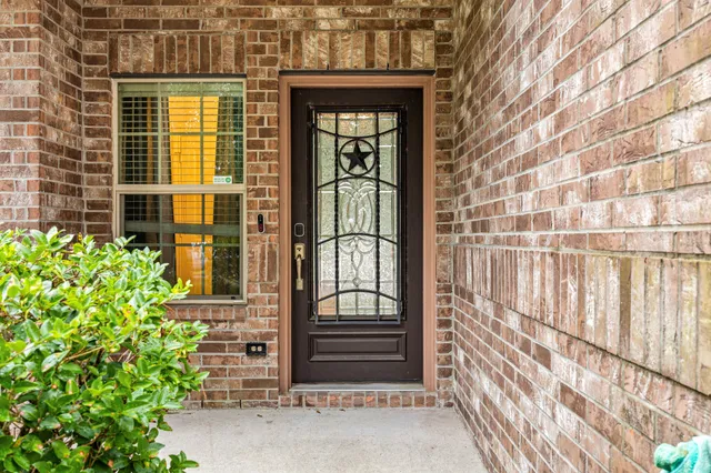 a view of a brick house with a large window