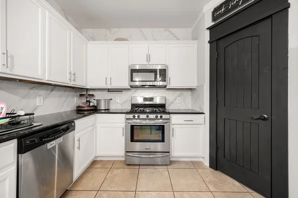 a kitchen with cabinets and appliances