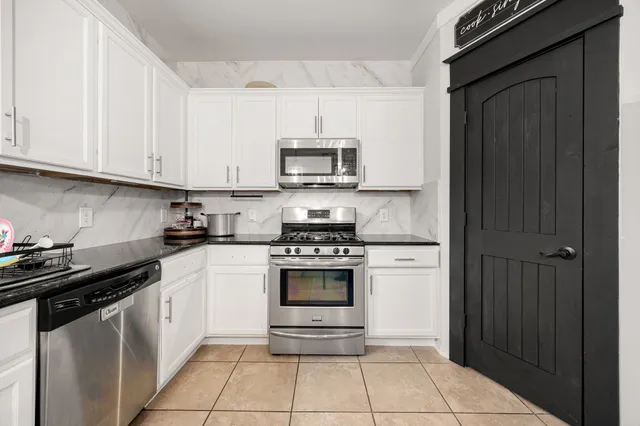 a kitchen with cabinets and appliances