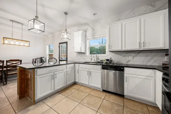 a kitchen with stainless steel appliances granite countertop a sink and cabinets