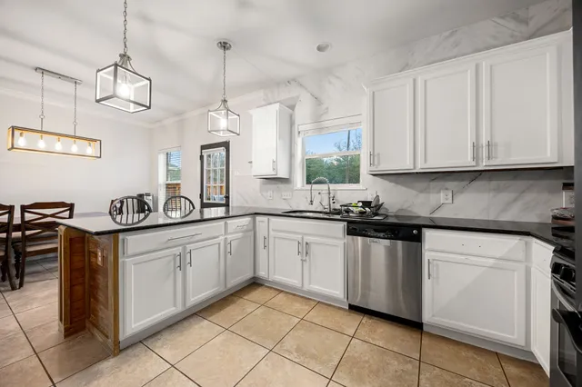 a kitchen with stainless steel appliances granite countertop a sink and cabinets