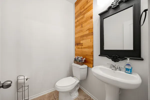 a bathroom with a sink toilet and mirror