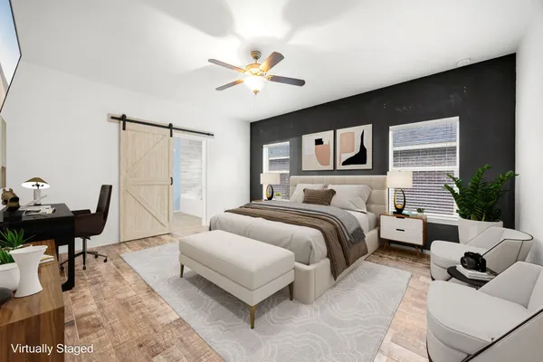 a spacious bedroom with a bed and couch