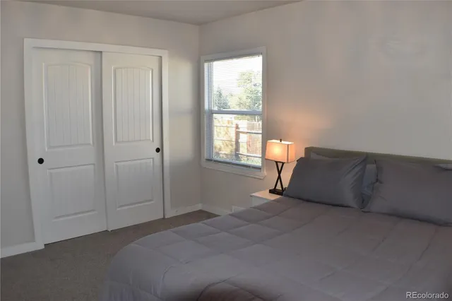 a room with a bed and window