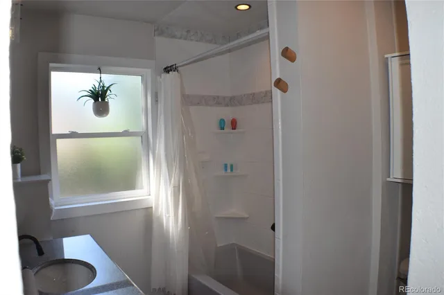 a bathroom with a shower and a window