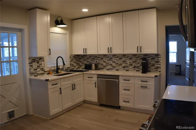 a kitchen with stainless steel appliances a sink stove and cabinets