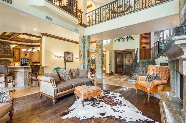 a living room with furniture a rug and a chandelier