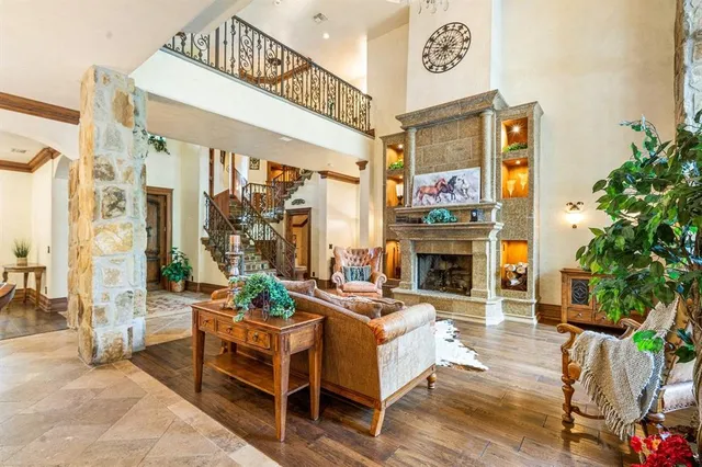 a living room with furniture a fireplace and a potted plants