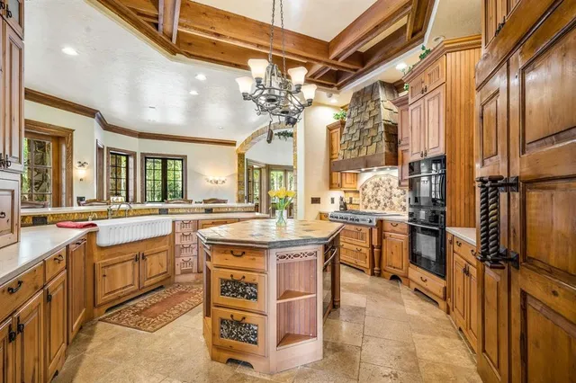 a kitchen with stainless steel appliances granite countertop a sink and cabinets