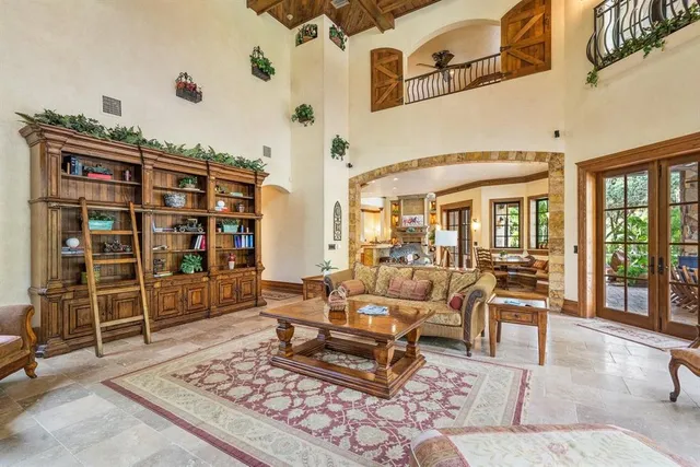 a living room with furniture a rug and a bookshelf