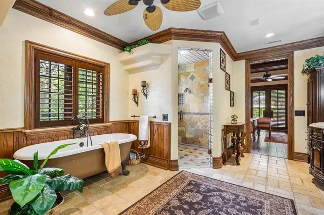 a living room with patio furniture and a large window