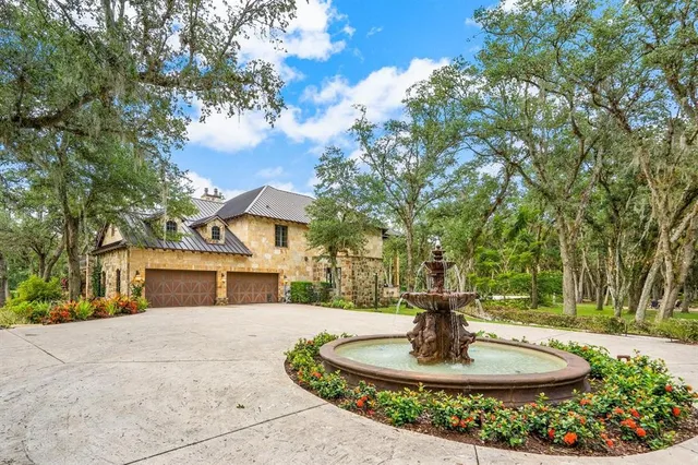 a house with large trees in front of it