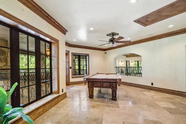 a view of a livingroom with furniture a dinning room and windows