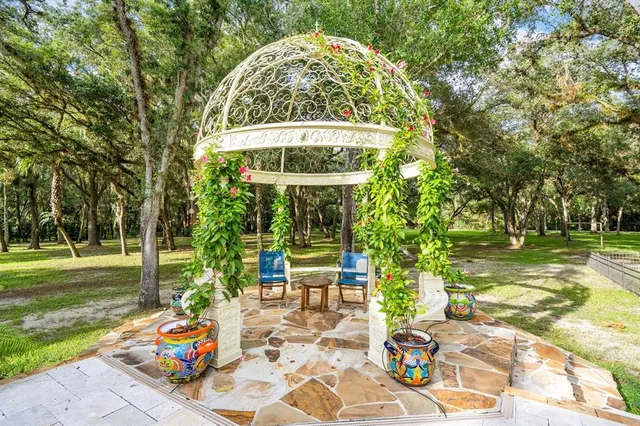 a backyard of a house with table and chairs