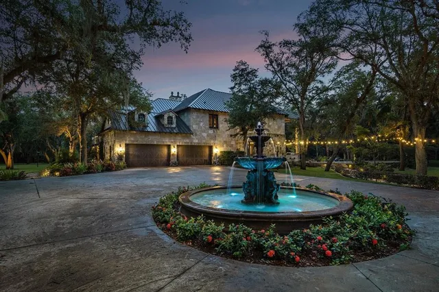 a view of a house with a fountain in a yard