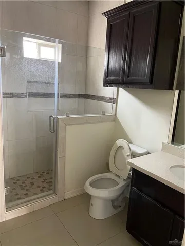 a bathroom with a toilet sink and shower