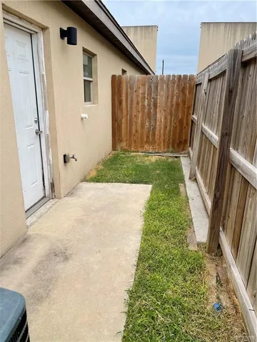 a view of a backyard with wooden fence