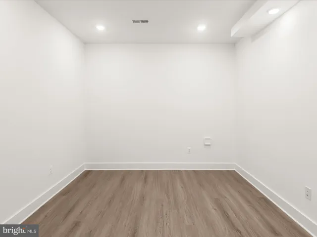 a view of an empty room with window and fire place