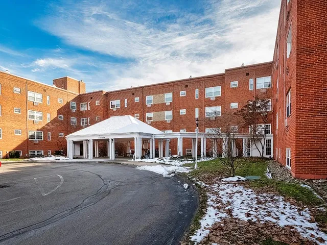 a front view of a building with garden