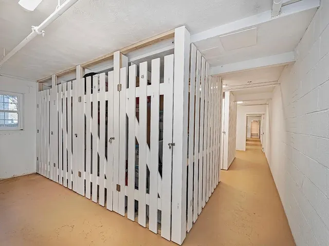 a view of a hallway with a wooden floor and entryway