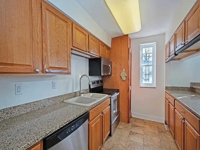 a kitchen with stainless steel appliances granite countertop a sink stove and cabinets