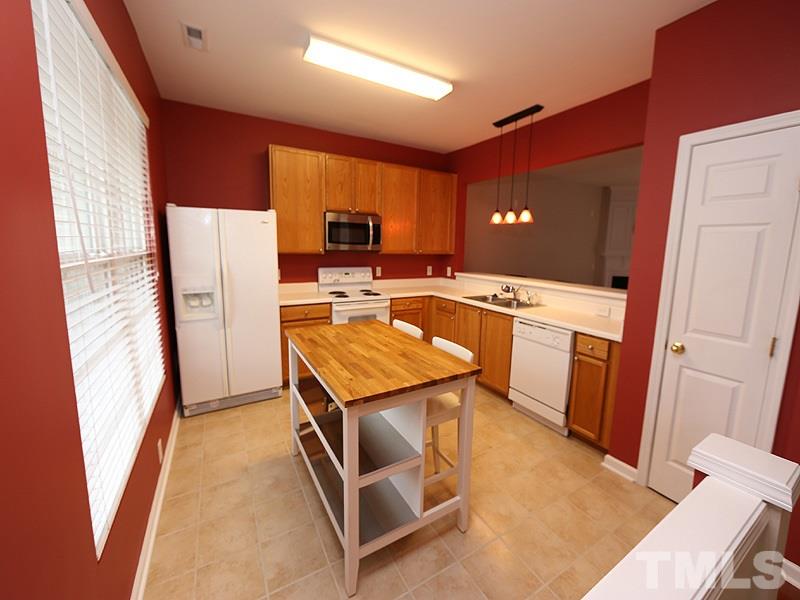 8519 Silhouette Place Raleigh, NC 27613 - Photo 2 of 19 a kitchen with stainless steel appliances granite countertop a refrigerator a stove top oven a sink and dishwasher