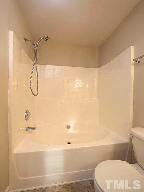 8519 Silhouette Place Raleigh, NC 27613 - Photo 12 of 19 a bathroom with a toilet and a bath tub