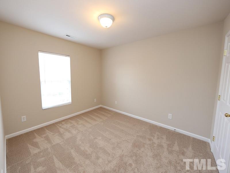 8519 Silhouette Place Raleigh, NC 27613 - Photo 14 of 19 an empty room with a window