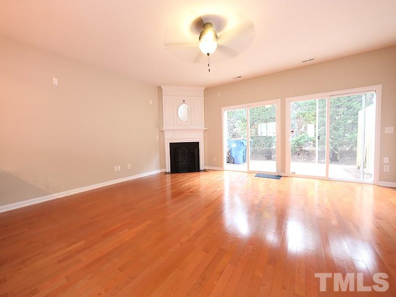 8519 Silhouette Place Raleigh, NC 27613 - Photo 5 of 19 a view of an empty room with wooden floor and a window