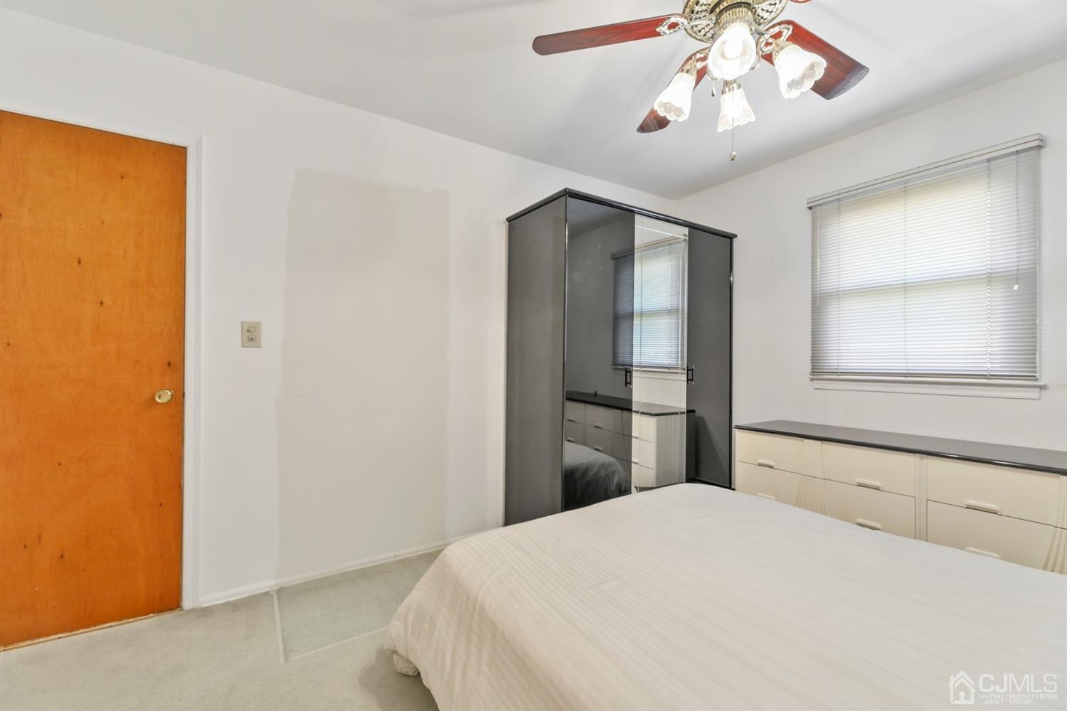 29 Ventnor Drive Edison, NJ 08820 - Photo 17 of 20 a bedroom with a bed and a chandelier
