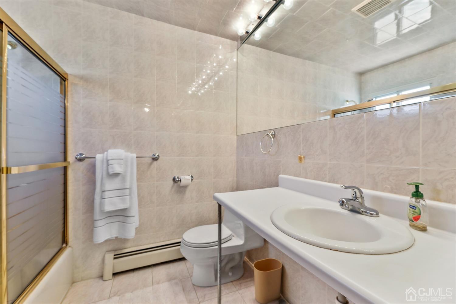 29 Ventnor Drive Edison, NJ 08820 - Photo 18 of 20 a bathroom with a sink a toilet and shower