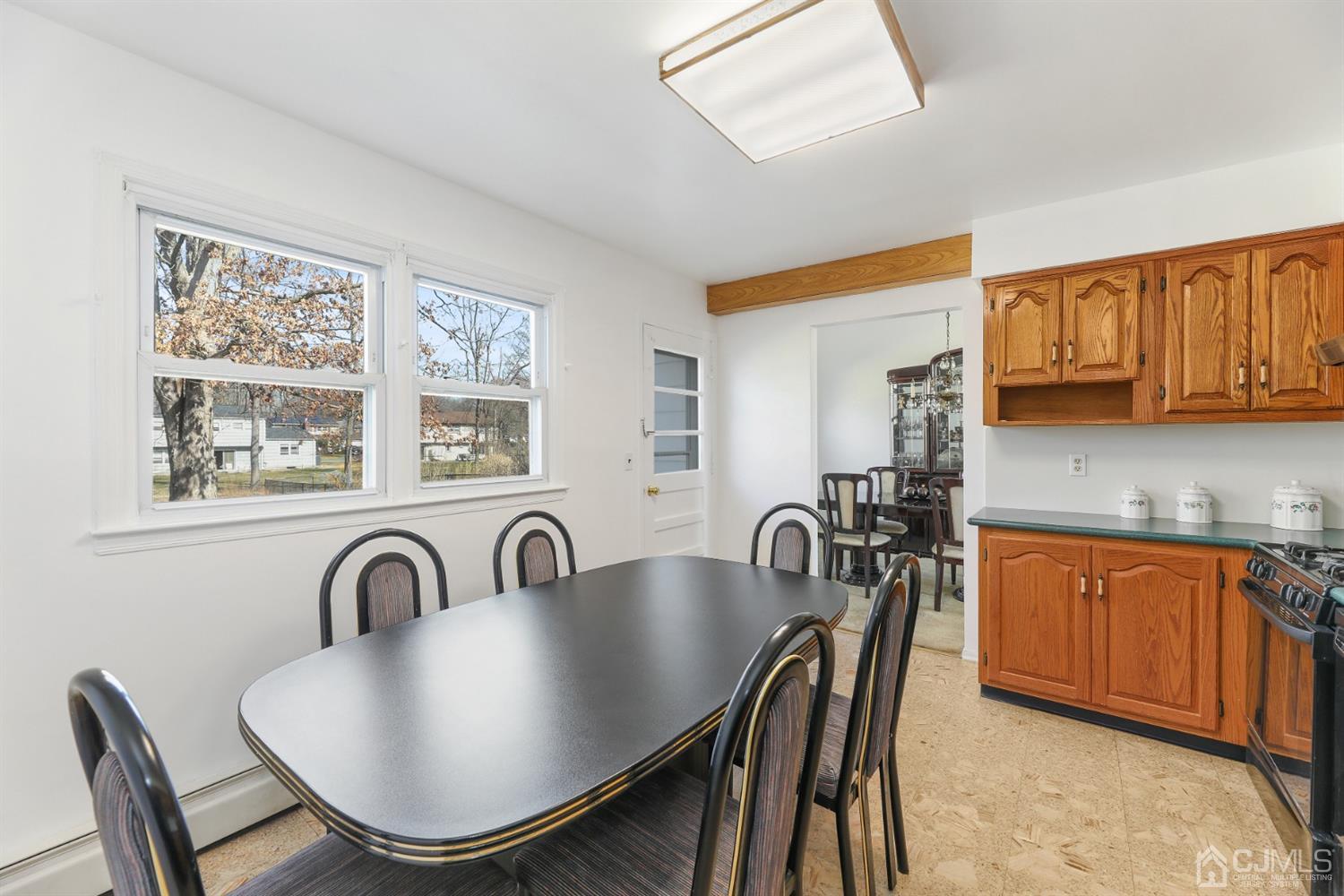 29 Ventnor Drive Edison, NJ 08820 - Photo 7 of 20 a kitchen with stainless steel appliances a table and chairs