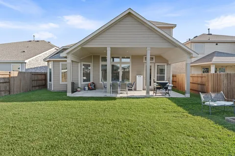 a view of a house with a yard and sitting area
