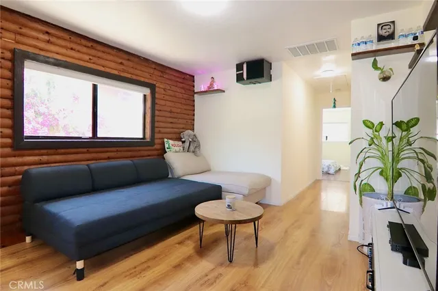 a living room with furniture and a potted plant