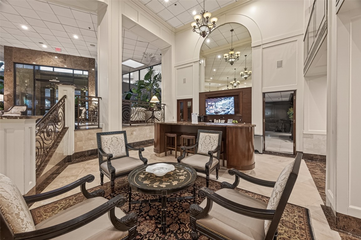 3525 Sage Road, Unit 1305 Houston, TX 77056 - Photo 18 of 30 a view of a dining room with furniture a chandelier and wooden floor