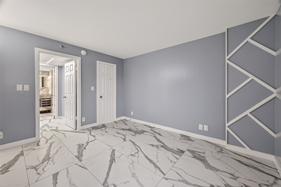 3525 Sage Road, Unit 1305 Houston, TX 77056 - Photo 23 of 30 a view of a room with a bed and wooden floor