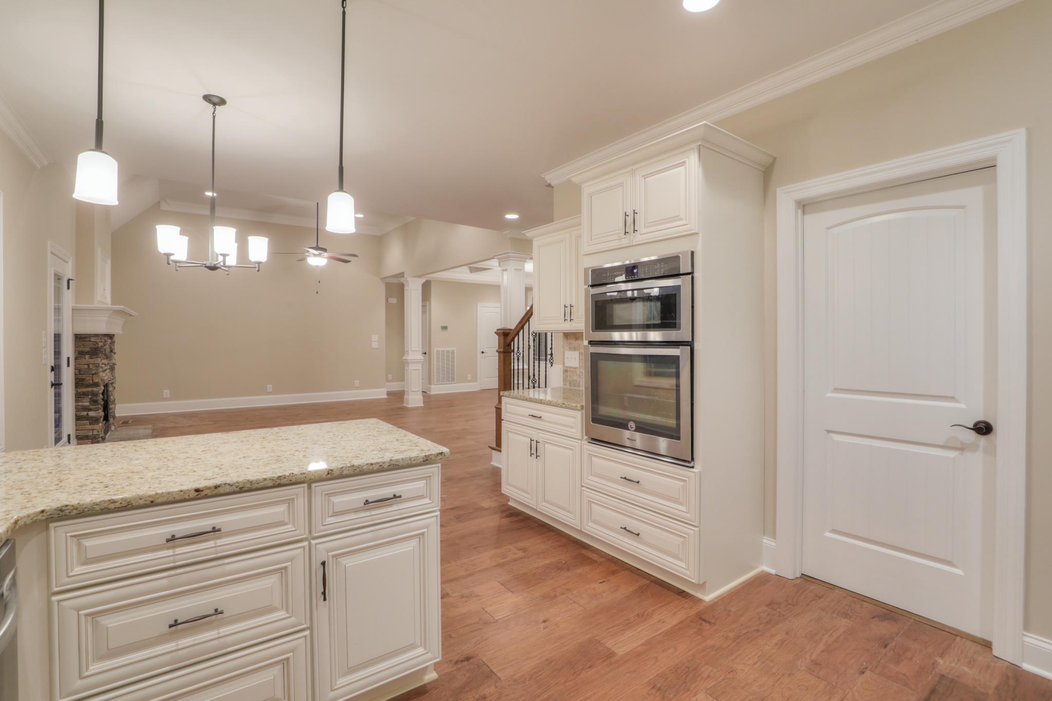 2231 Cairo Bend Road Lebanon, TN 37087 - Photo 11 of 29 a kitchen with stainless steel appliances granite countertop cabinets and wooden floor