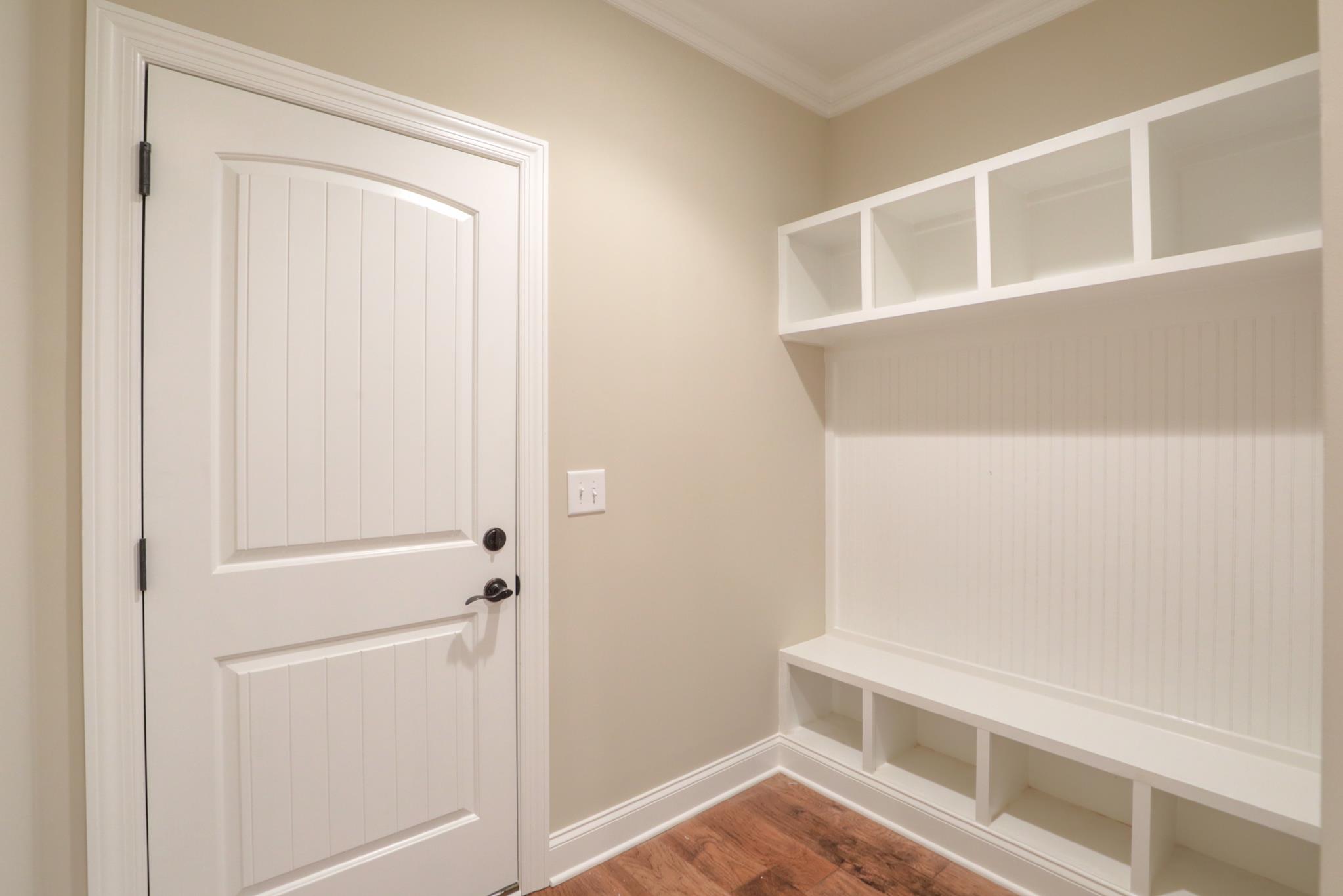 2231 Cairo Bend Road Lebanon, TN 37087 - Photo 13 of 29 a view of an empty room with wooden floor and a window