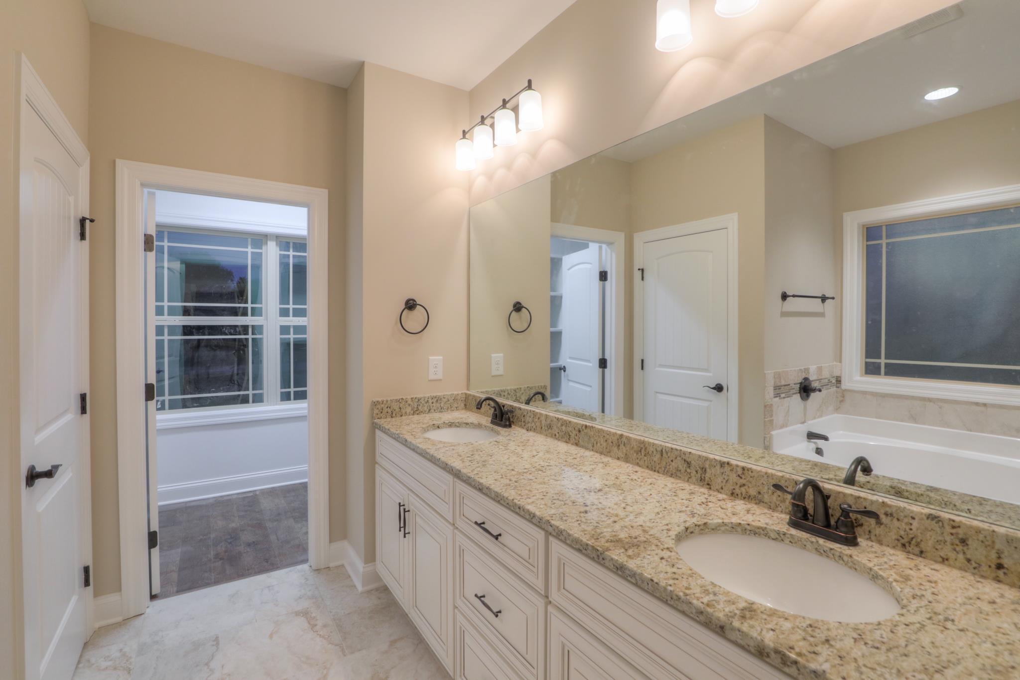 2231 Cairo Bend Road Lebanon, TN 37087 - Photo 17 of 29 a bathroom with a granite countertop double vanity sink and a mirror