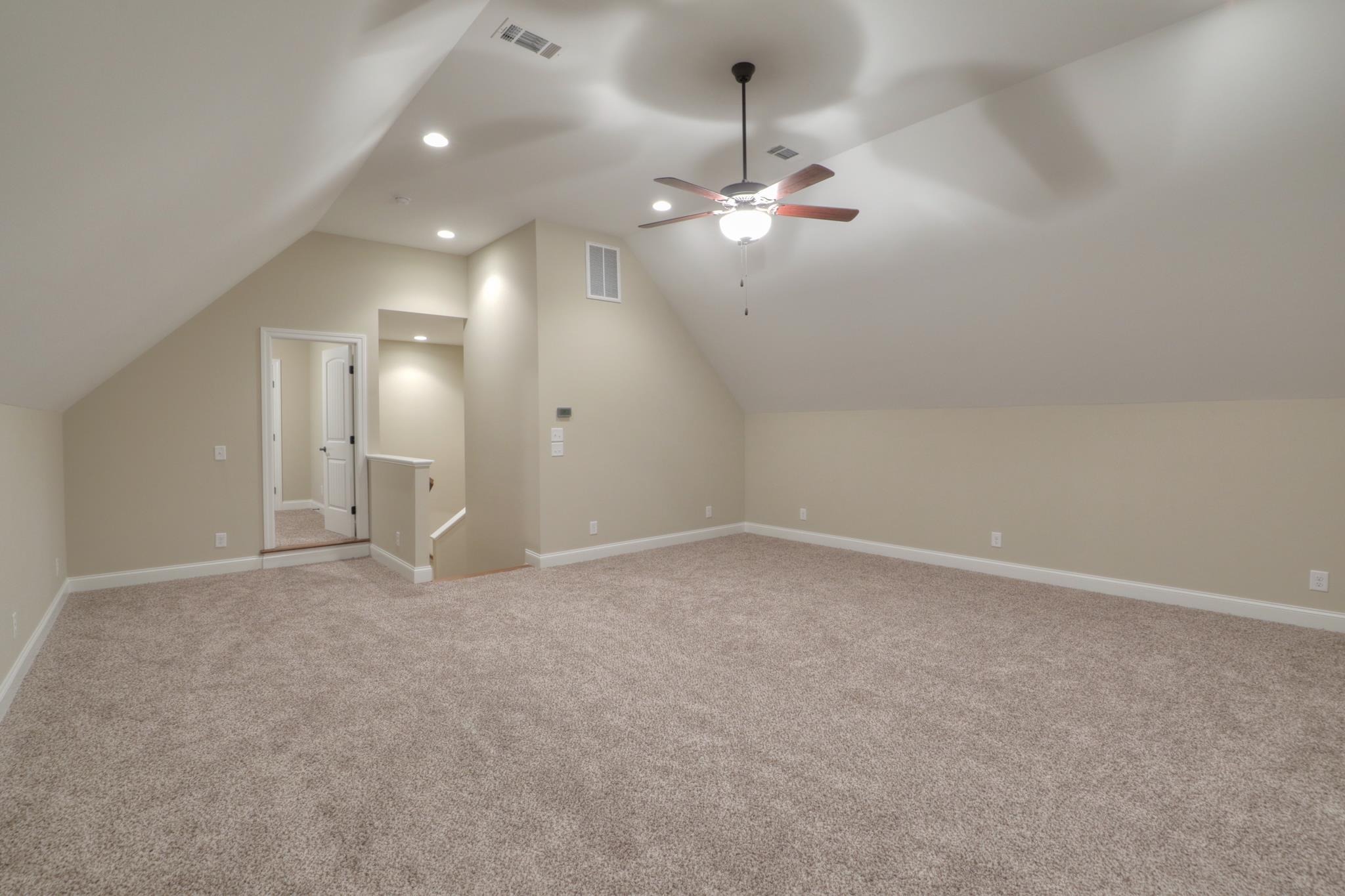 2231 Cairo Bend Road Lebanon, TN 37087 - Photo 26 of 29 an empty room with a bathroom and chandelier fan