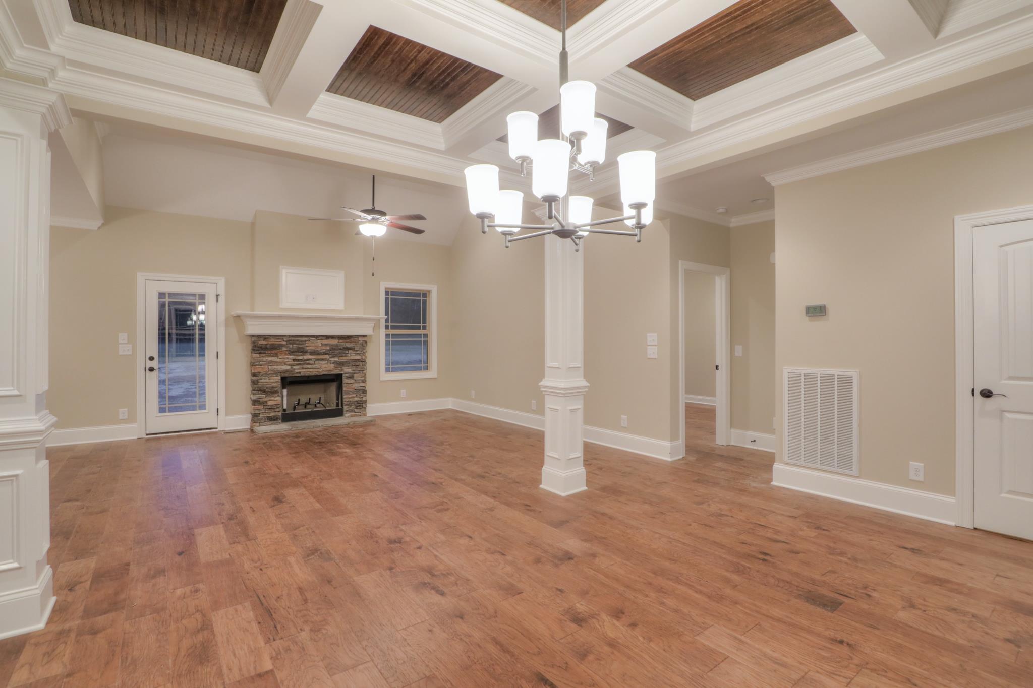 2231 Cairo Bend Road Lebanon, TN 37087 - Photo 6 of 29 an empty room with fireplace chandelier and windows