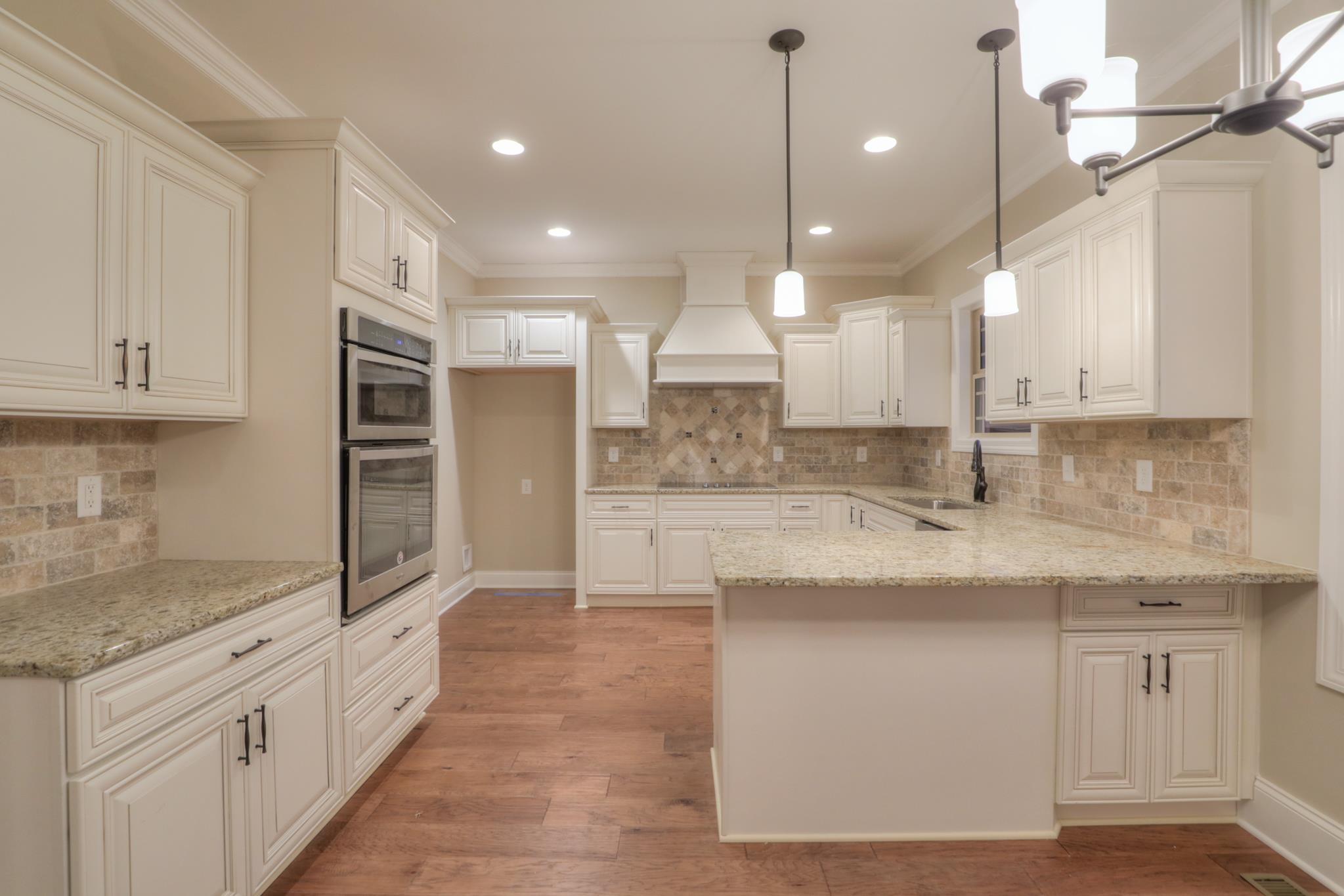 2231 Cairo Bend Road Lebanon, TN 37087 - Photo 9 of 29 a large kitchen with granite countertop a sink a counter top space stainless steel appliances and cabinets