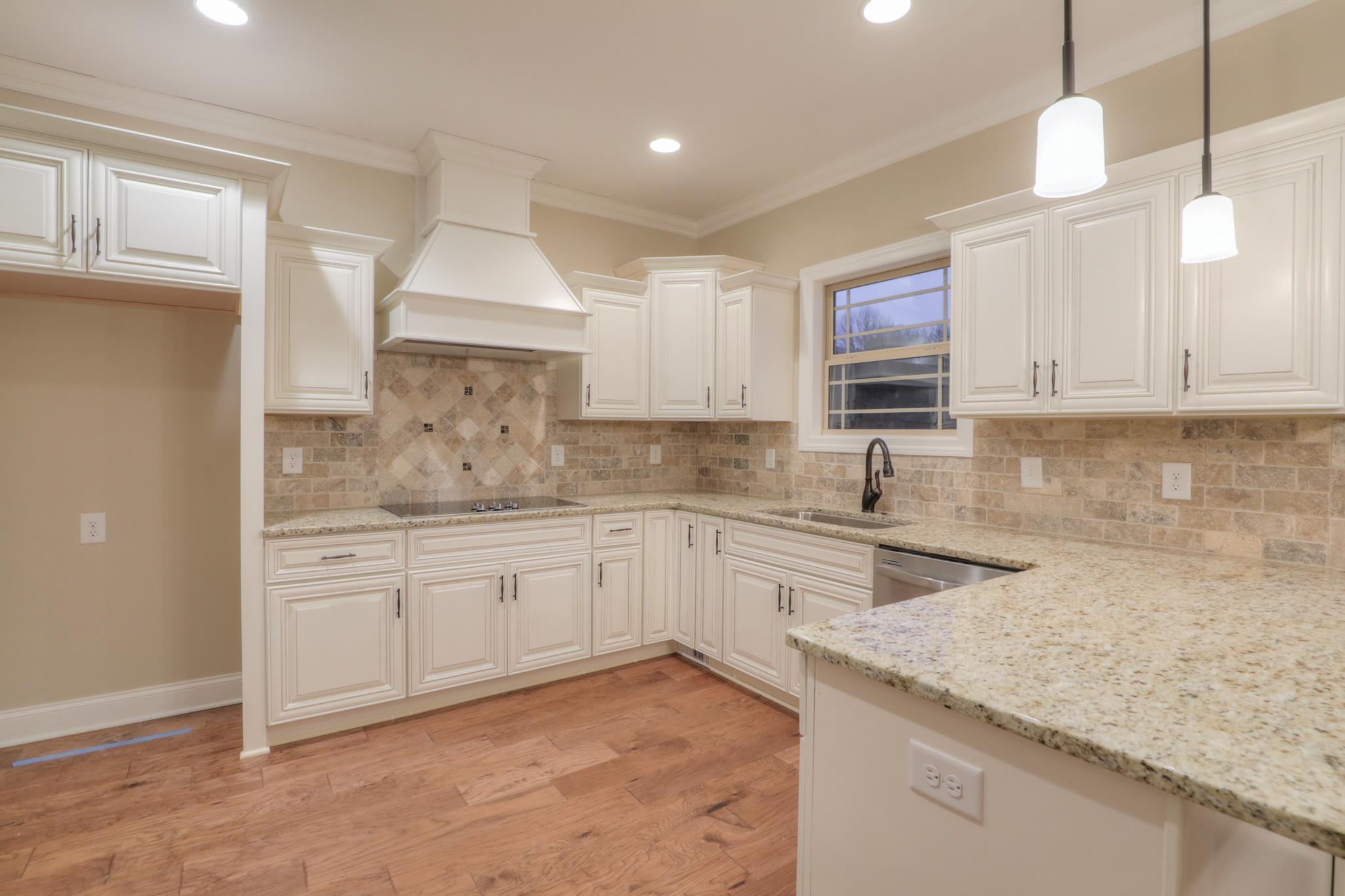 2231 Cairo Bend Road Lebanon, TN 37087 - Photo 10 of 29 a kitchen with granite countertop a sink stainless steel appliances and cabinets