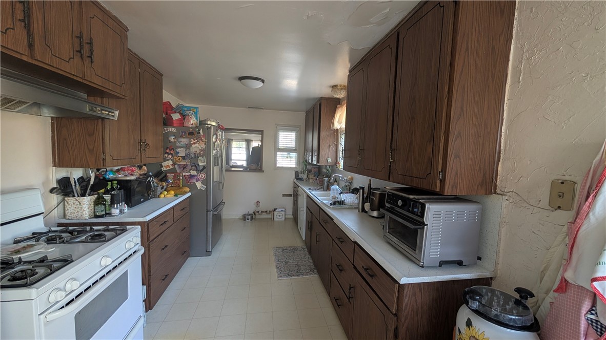 3762 Mohawk Street Pasadena, CA 91107 - Photo 11 of 20 a kitchen with kitchen island granite countertop a sink stove and refrigerator