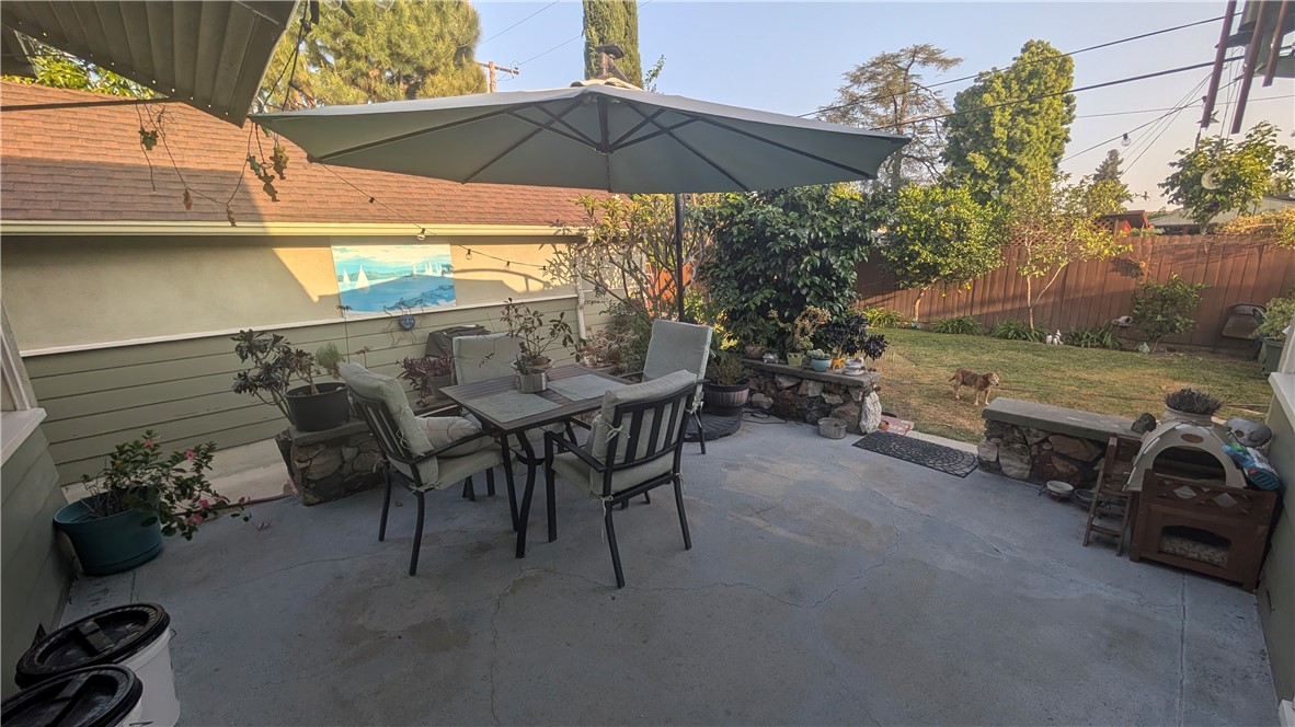 3762 Mohawk Street Pasadena, CA 91107 - Photo 20 of 20 a view of a patio with table and chairs under an umbrella