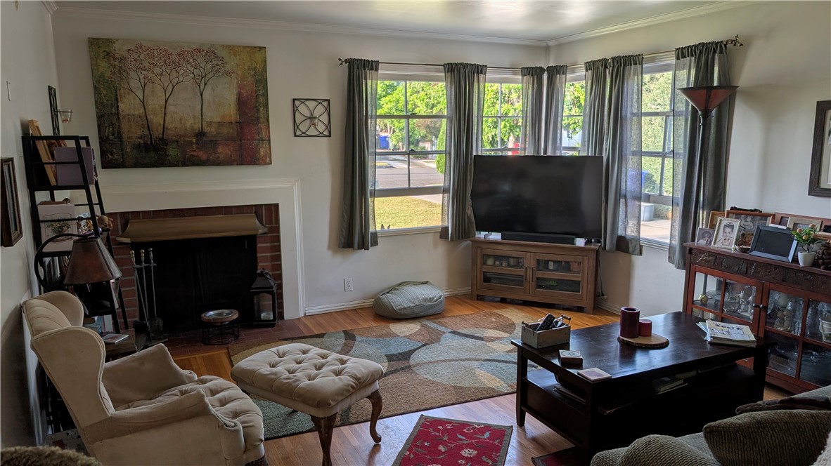 3762 Mohawk Street Pasadena, CA 91107 - Photo 4 of 20 a living room with furniture a flat screen tv and a fireplace