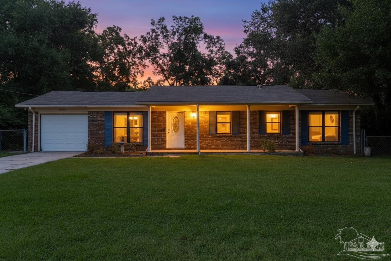 a front view of a house with a garden