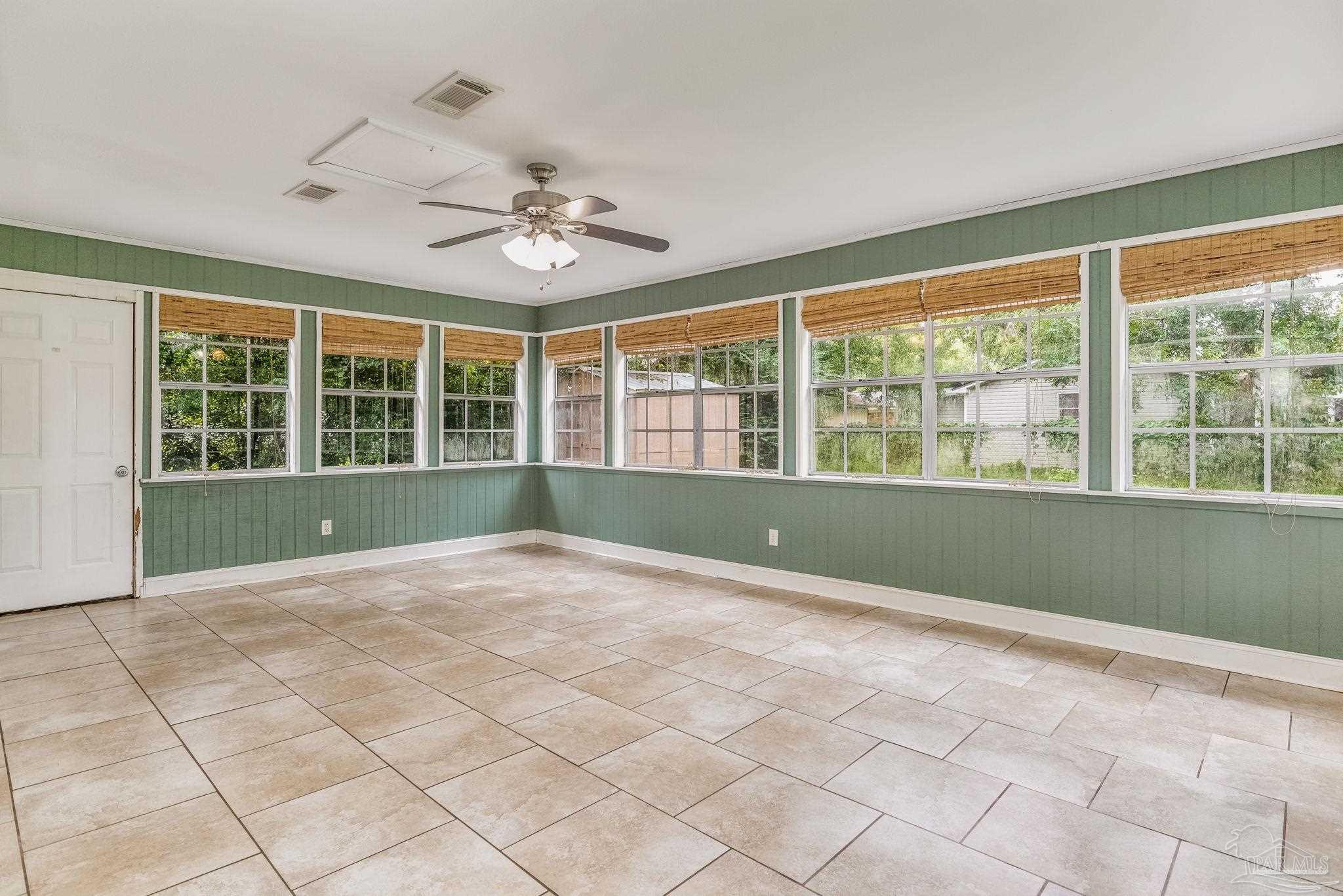 1422 Starlight Drive Cantonment, FL 32533 - Photo 18 of 49 a view of an empty room with a window and kitchen view