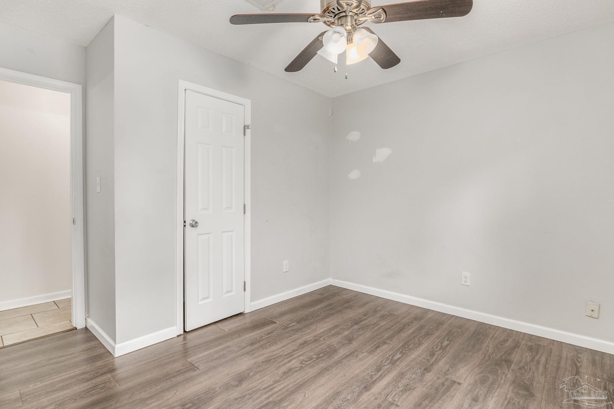 1422 Starlight Drive Cantonment, FL 32533 - Photo 20 of 49 an empty room with wooden floor closet and fan