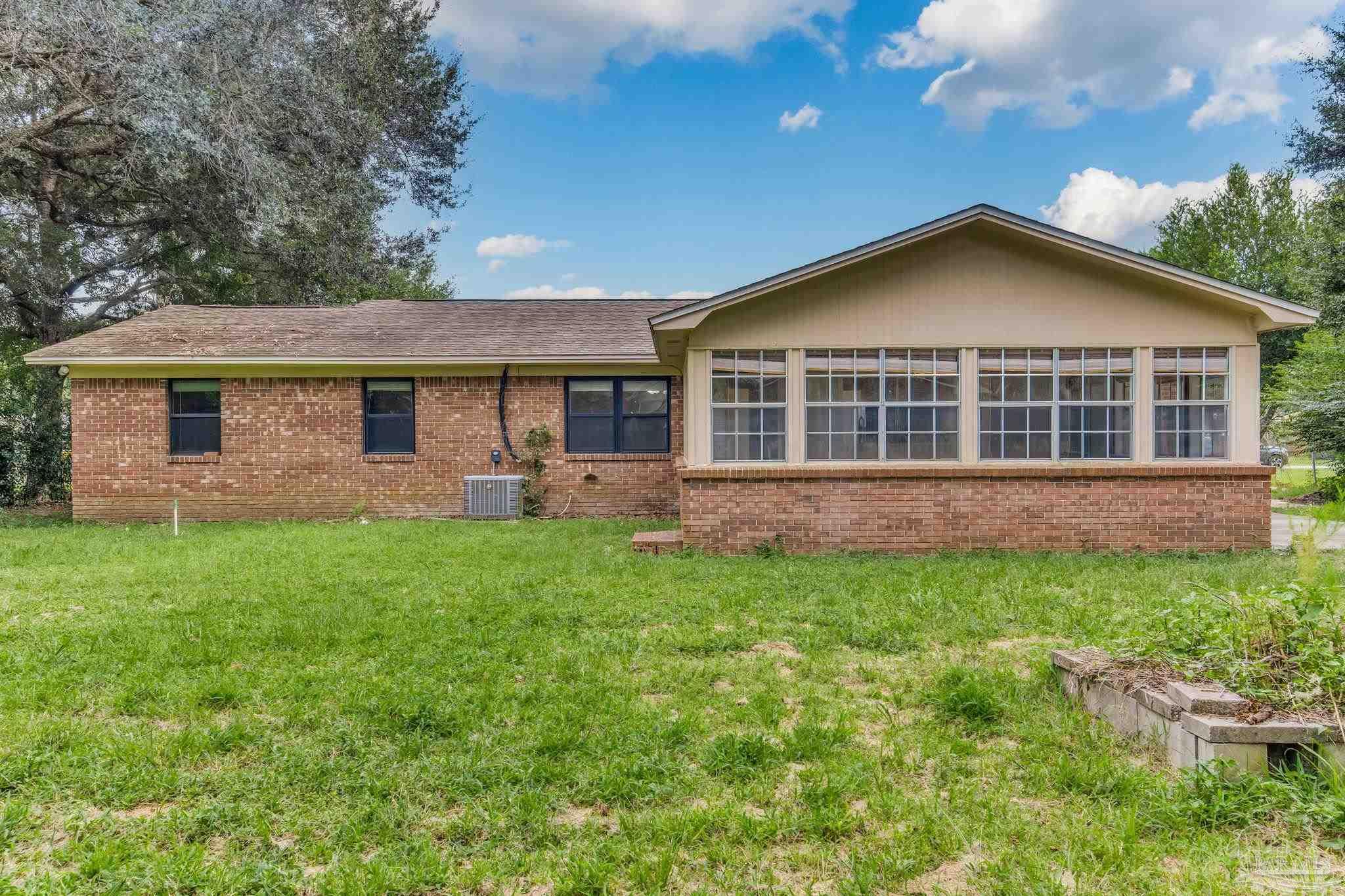 1422 Starlight Drive Cantonment, FL 32533 - Photo 2 of 49 a view of a house with backyard and garden